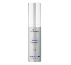 A bottle of SkinMedica Retinol Complex 1.0 with a white cylindrical shape and text in purple.