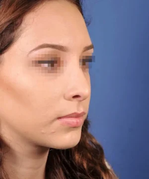 A person with blurred eyes and long wavy hair is shown in a side profile against a blue background.