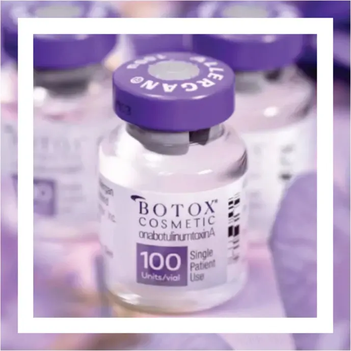 A vial of Botox Cosmetic on a blurred purple background. The label reads "100 Units/vial" and "Single Patient Use.